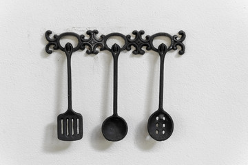 kitchen utensils hanging on white wall - For decorate