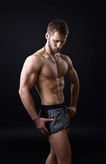 Fototapeta na wymiar Young bodybuilder on a black background
