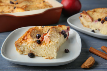 Delicious bread pudding with berries on table