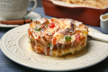 Delicious bread pudding with candied fruits on table