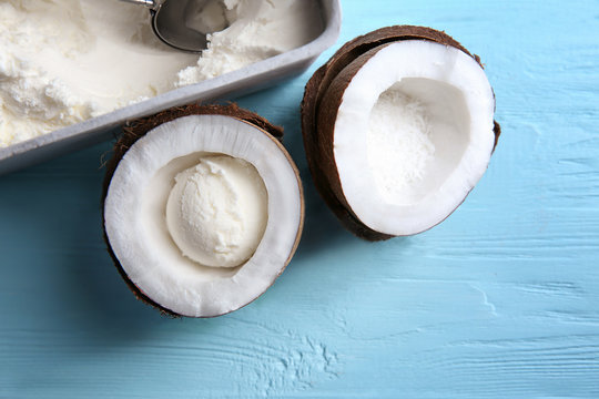 Coconut ice cream and fresh nut on wooden table