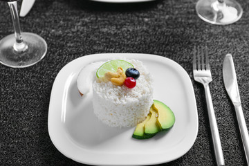 Plate with delicious tasty coconut rice on table