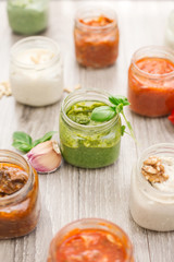 selection of  sauces inside jar over wooden table
