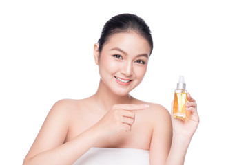 Fototapeta premium Health, spa and beauty concept. Asian woman with perfect skin holding oil bottle