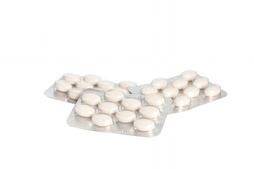 Medicinal white pills with expired shelf life on a white background. Isolated