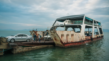 An old rusty ferry docking into port