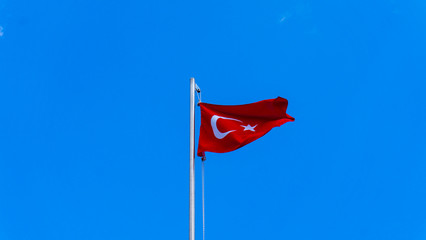 turkish flag waving in blue sky