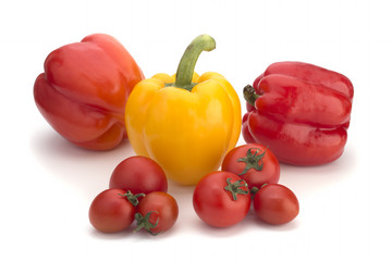 Yellow and red sweet pepper and red cherry tomatoes on a white background