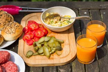 Barbecue, BBQ in the garden. Ingredients. Fresh burger with beef on wooden table.