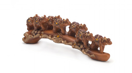 Seven Indian elephants made of sandalwood on a white background