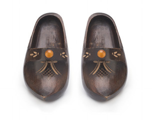 Wooden clogs with amber decoration isolated on white background