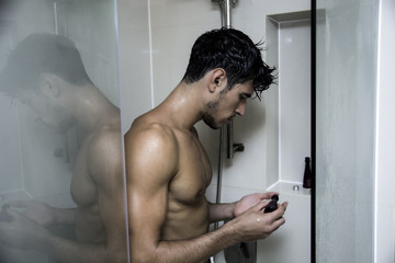 Close up Attractive Young Bare Muscular Man after Taking Shower, Getting Soap or Bathfoam or Shampoo