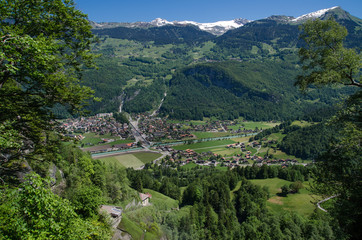 Fototapeta na wymiar Swiss village in valley near Reichenbach falls (Reichenbachfall) at Swiss Alps, Switzerland
