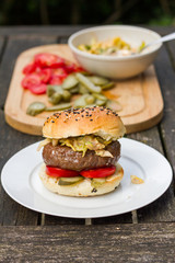 Barbecue, BBQ in the garden. Ingredients. Fresh burger with beef on wooden table.