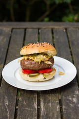 Barbecue, BBQ in the garden. Ingredients. Fresh burger with beef on wooden table.