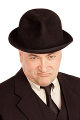 Contemptuous expression of man's face in black hat