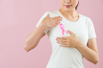 Asian girl put pink knot anti-breast cancer