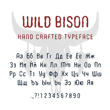 Hand drawn Wild bison font. Cyrillic alphabet vector letters, numbers, and signs. Buffalo skull with feathers vector illustration.