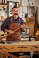 Happy Crazy Carpenter/Middle aged handsome carpenter  finished making horse toy and smiles to the...