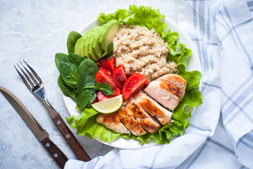Fresh salad from quinoa, chicken breast, spinach, lettuce and tomato