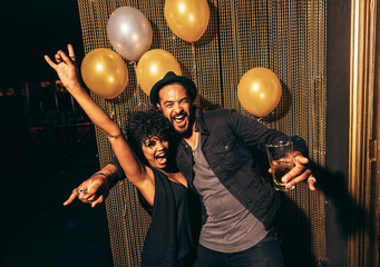 Young couple enjoying a party at club