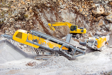 Digger and excavator in the quarry