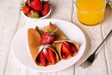 crepes with berries and orange juice, horizontal, top view, closeup