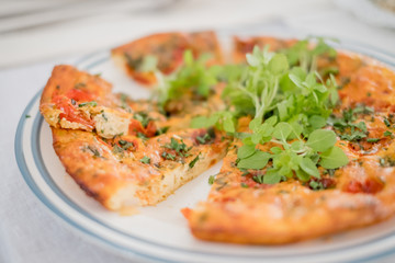 Fritatta with tomatoes and fresh herbs