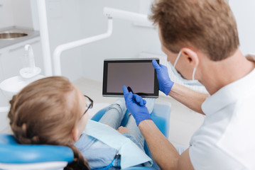 Delicate competent dentist giving a little lecture