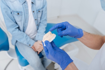 Creative wonderful dentist illustrating his lecture