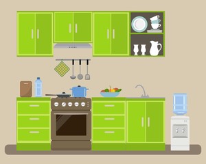 Modern kitchen in a green color. There is a kitchen furniture, a stove, a water cooler and other objects in the picture. On the table is a plate of vegetables. Vector flat illustration.