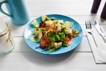 Healthy restaurant food, salmon and cod fish salad closeup