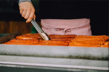 Man cooking sausages on the grill