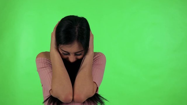 young attractive asian woman is afraid - green screen studio