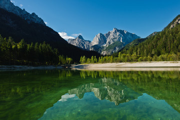 Morning reflections of slovenian Alps on a calm surface of a lake Jasna at Kranjska Gora, Slovenia