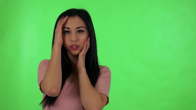 young attractive asian woman does various poses - green screen studio