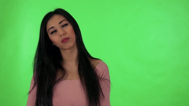 young attractive asian woman is boring - green screen studio