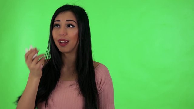young attractive asian woman blows her nose into a handkerchief - green screen