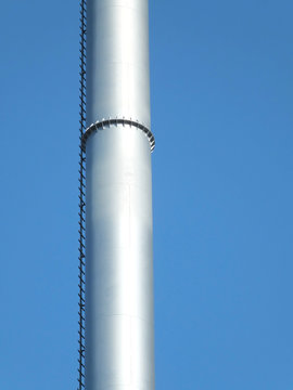 metal industrial chimney against blue sky