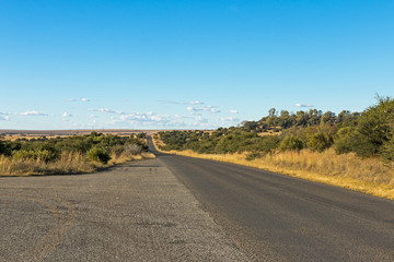 Empty Rural Asphalt Road Running Through Dry Winter Landscape