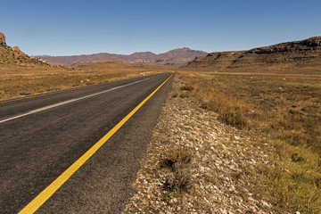 Fototapeta na wymiar Asphalt Road Running Through Dry Winter Landscape in South Africa