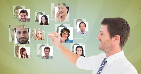 Fototapeta premium businessman using futuristic screen with flying portraits