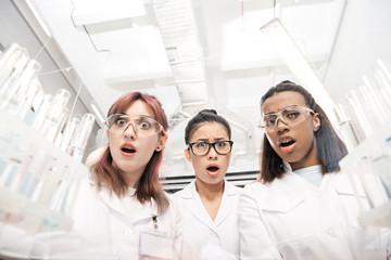 low angle view of scientists group in white coats in laboratory