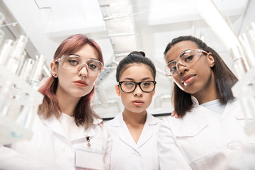 low angle view of scientists group in white coats in laboratory