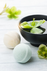 Bath bombs on white wooden background