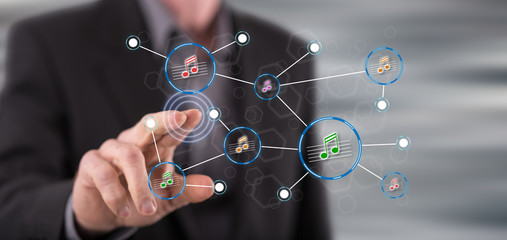 Man touching a music sharing network on a touch screen