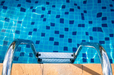 Swimming pool with stair at hotel close up