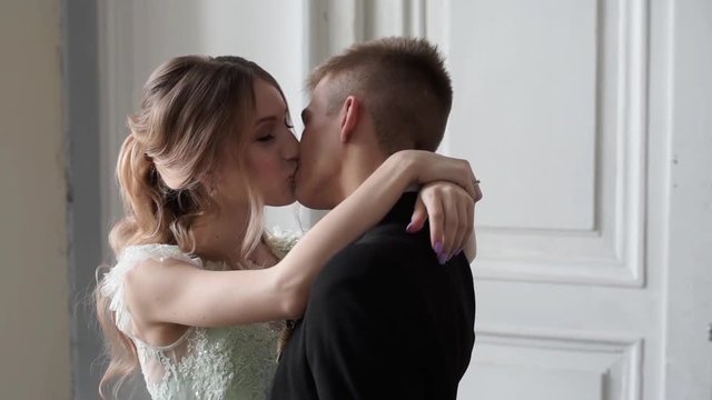 Wedding couple indoors is hugging each other