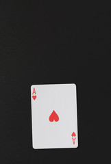Ace of hearts on a black background, playing cards, copyspace for you marketing text vertical photo