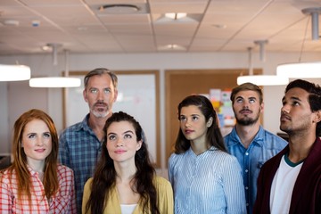 Fototapeta premium Creative business team standing together and looking up